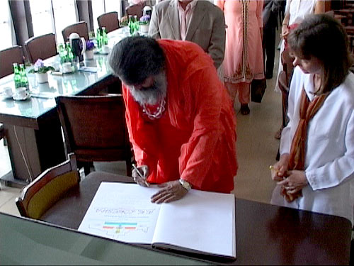 Swamiji signs the Guest Book Swamiji signs the Guest Book