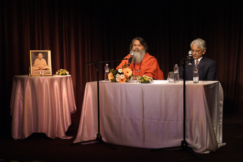Swamiji shares the speaker\'s desk with Indian Ambassador to Czech Republic, H.E. Shree P.S. Raghavan Swamiji shares the speaker\'s desk with Indian Ambassador to Czech Republic, H.E. Shree P.S. Raghavan
